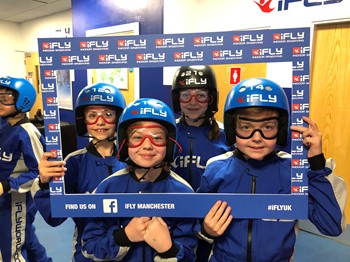 Four people at iFLY in a frame