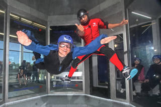 Two people flyign at iFLY - indoor skydiving UK