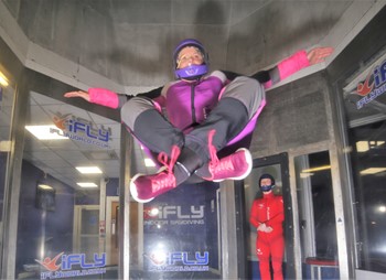 Person flying at iFLY in a weird pose
