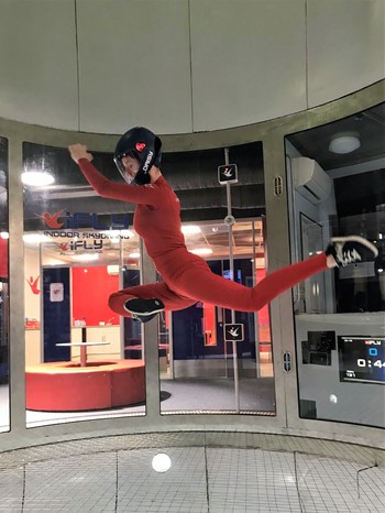Person in a weird pose flying at iFLY