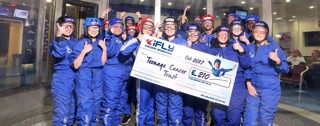 Group of people with a check at iFLY